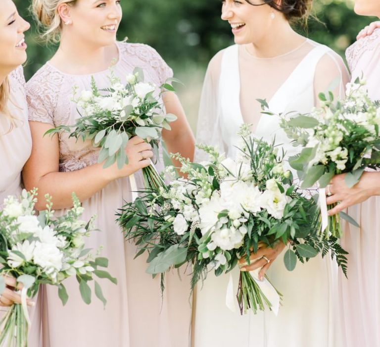 Bride and bridesmaids with white wedding flowers