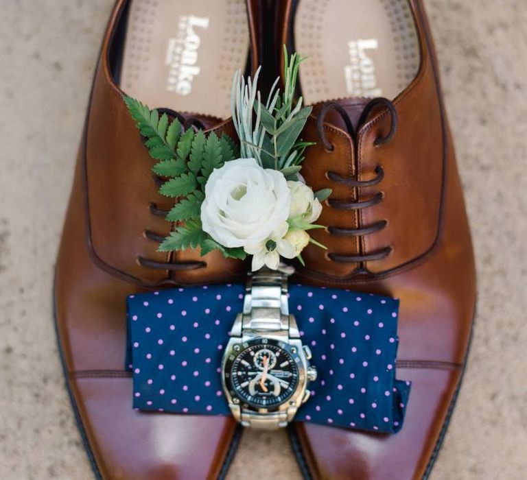 Brown brogue shoes for groom with white wedding flowers buttonhole