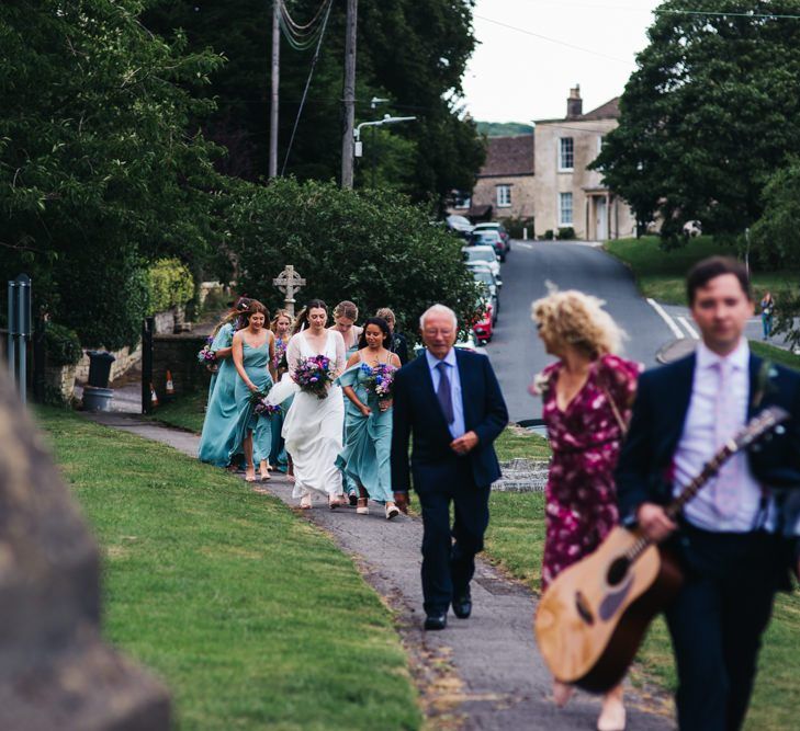 Bride and bridal party arrive at church ceremony