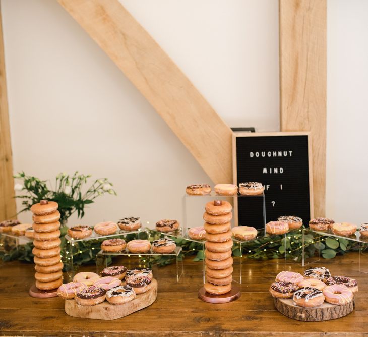 Doughnut table at wedding with peg board sign