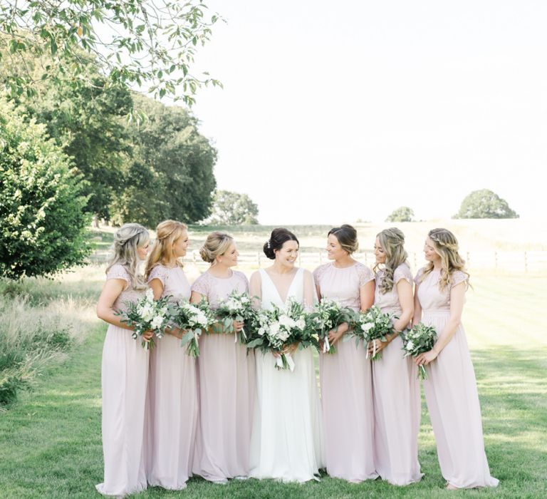 Blush bridesmaid dresses with white wedding flowers