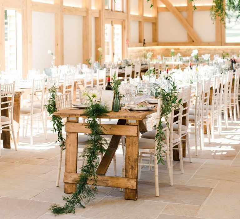 Foliage and white wedding flowers decor for wedding breakfast