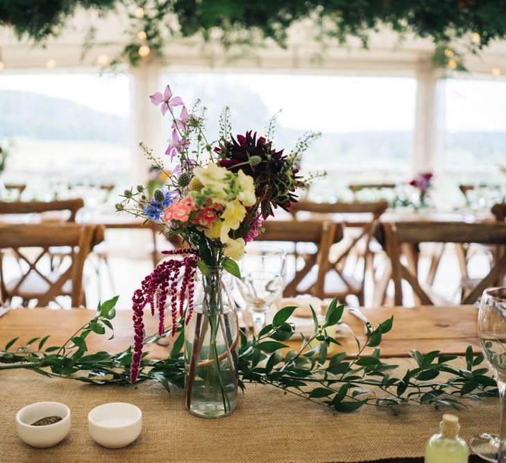 Wildflower table decor for marquee wedding matching the moon gate arch