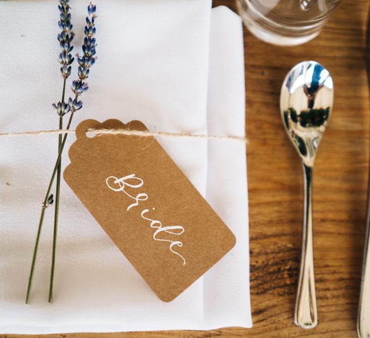 Wedding guest place setting with name tag and floral decor