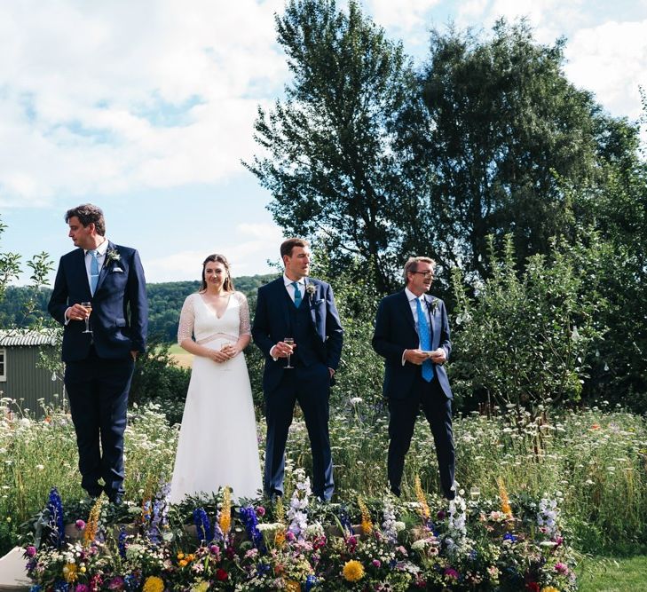 Bride and groom do wedding speeches during outside drinks