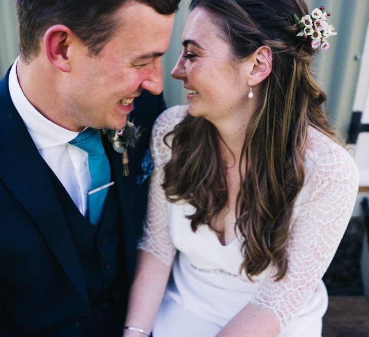 Bride and groom share a moment at marquee wedding with bridal hair down with flower hair pieces