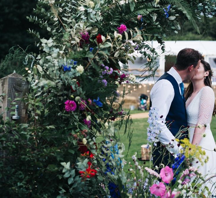 Wildflower moon gate arch at marquee wedding