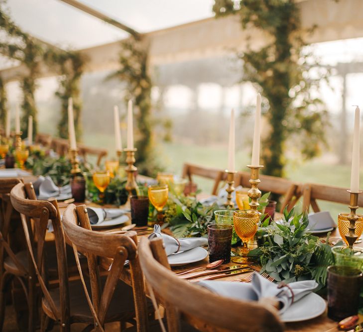 Marquee Wedding Reception Decor with Greenery tAble Runner, Gold Candle Sticks and Yellow Goblets