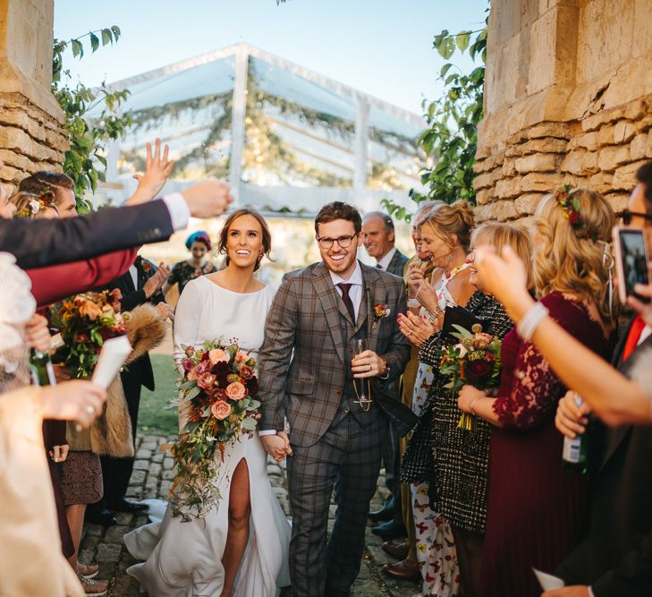 Confetti Moment with Bride in Front Split Wedding Dress and Groom in Check Suit