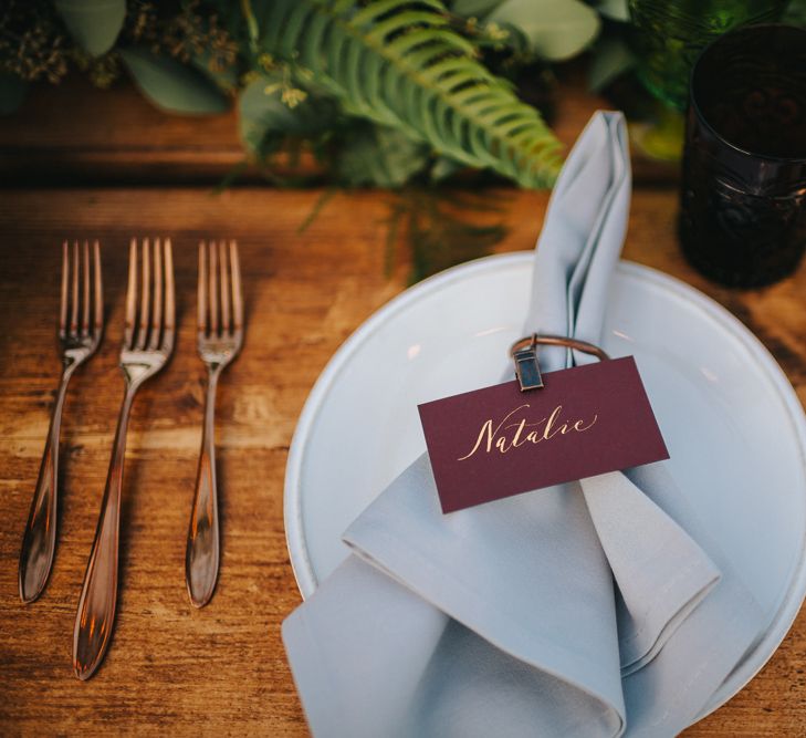 Elegant Place Setting with Gold Cutlery, Grey Napkin and Burgundy Name Place Card