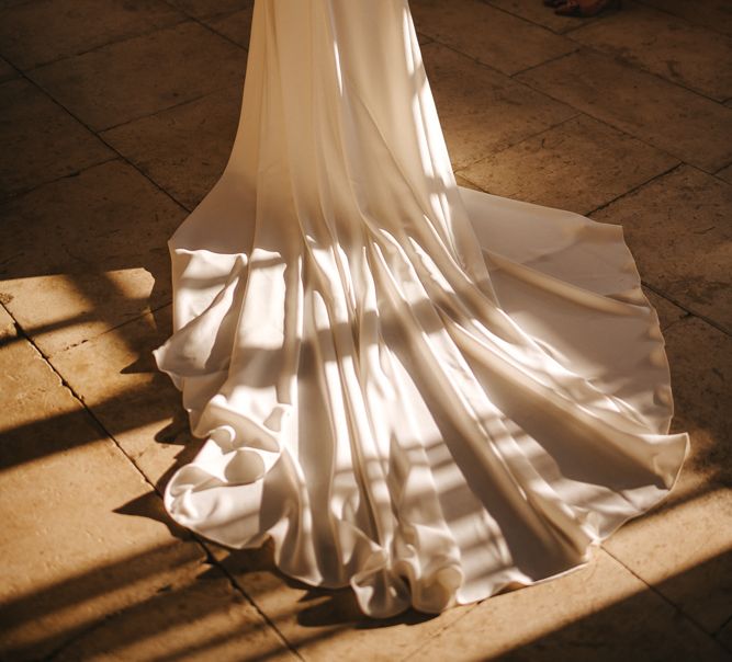 The Light Catching the Train of the Brides Pronovias Wedding Dress