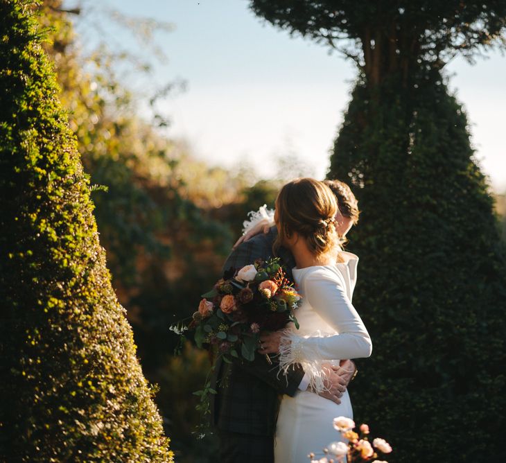 First Look with Bride in Pronovias Wedding Dress and Groom in Checked Suit