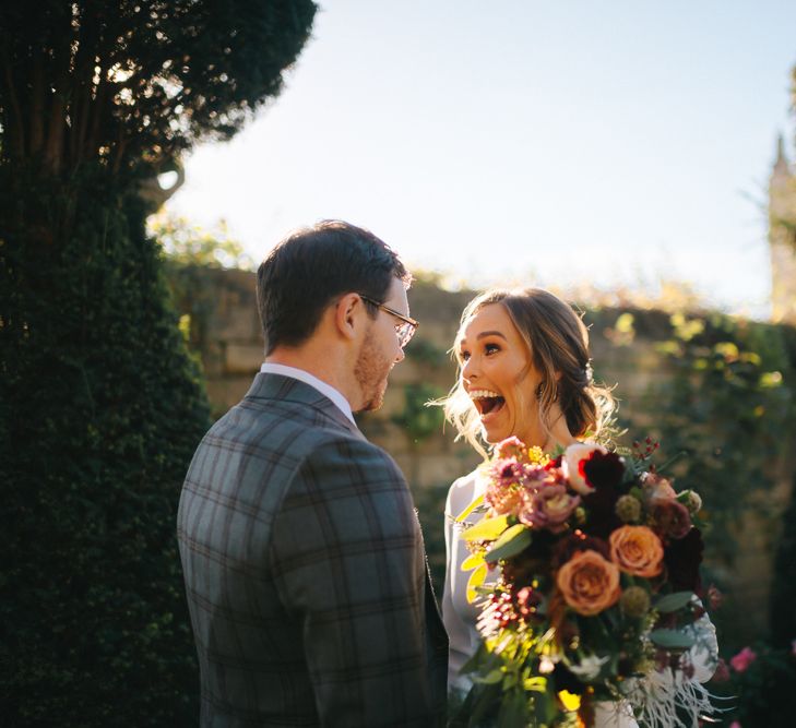 Happy Bride in Pronovias Wedding Dress and Groom in Checked Suit at Their First Look