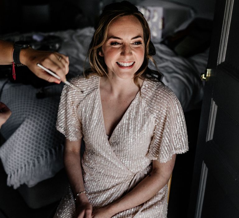 Wedding morning bridal preparations in sequin getting ready robe