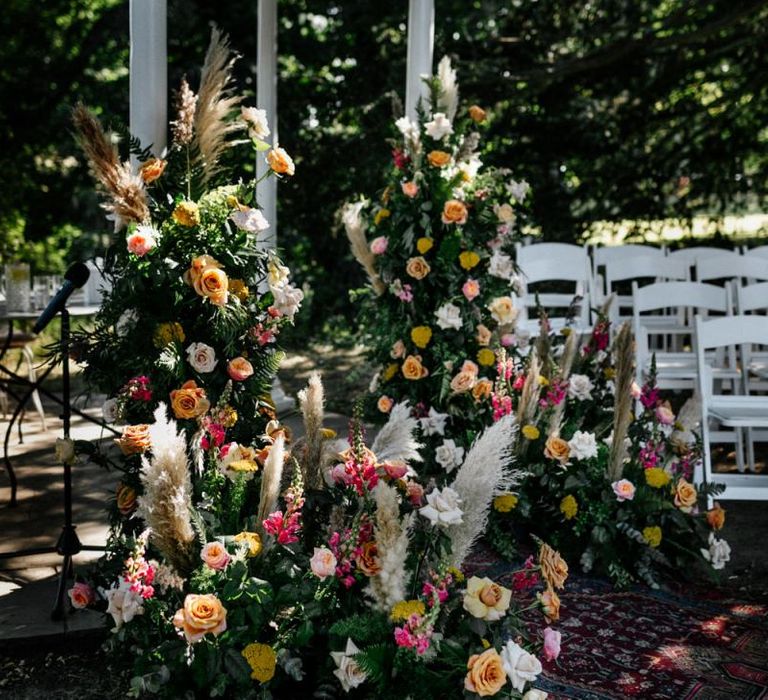 Colourful wedding floral arrangements with pampas grass