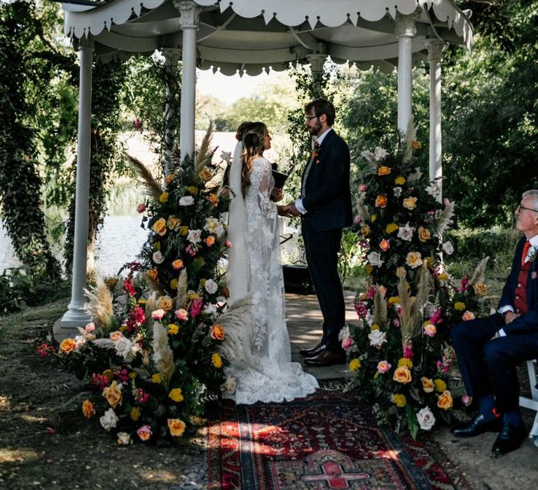 Bride and groom exchanging vows at outdoor wedding ceremony