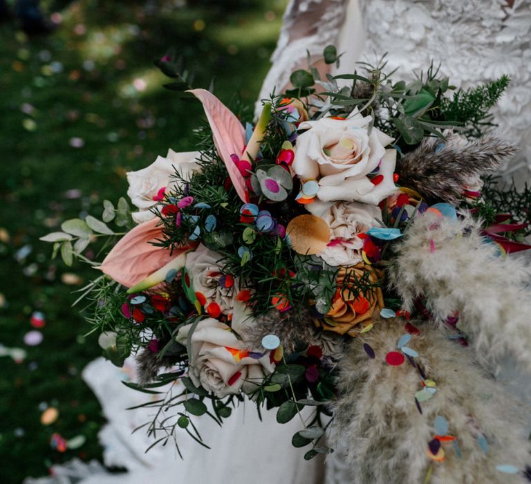 Boho wedding bouquet with pampas grass and anthuriums covered in confetti