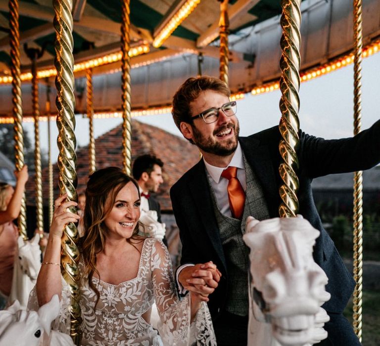 Bride and groom riding the carousel at Preston Court