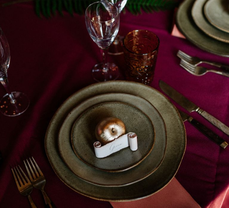 Place setting with spray painted fruit and scroll place name