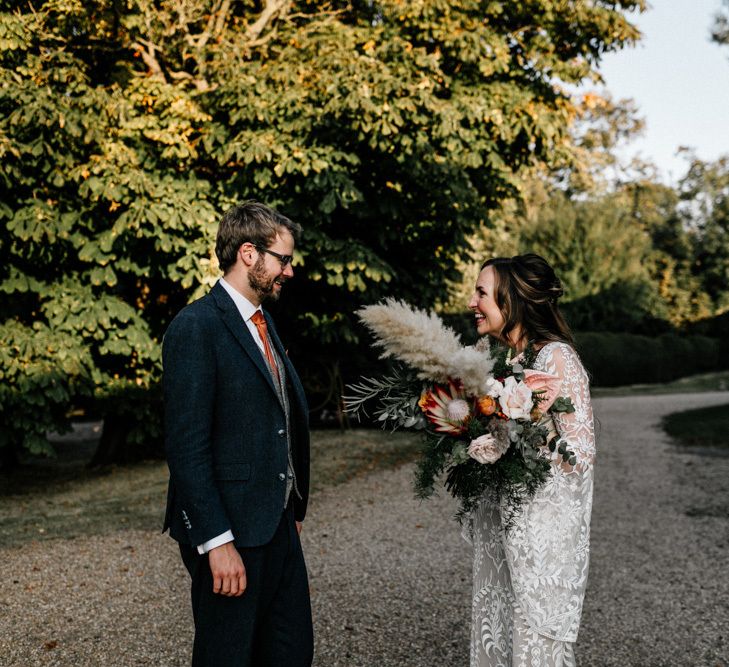 Bride and groom first look in evening wedding dress