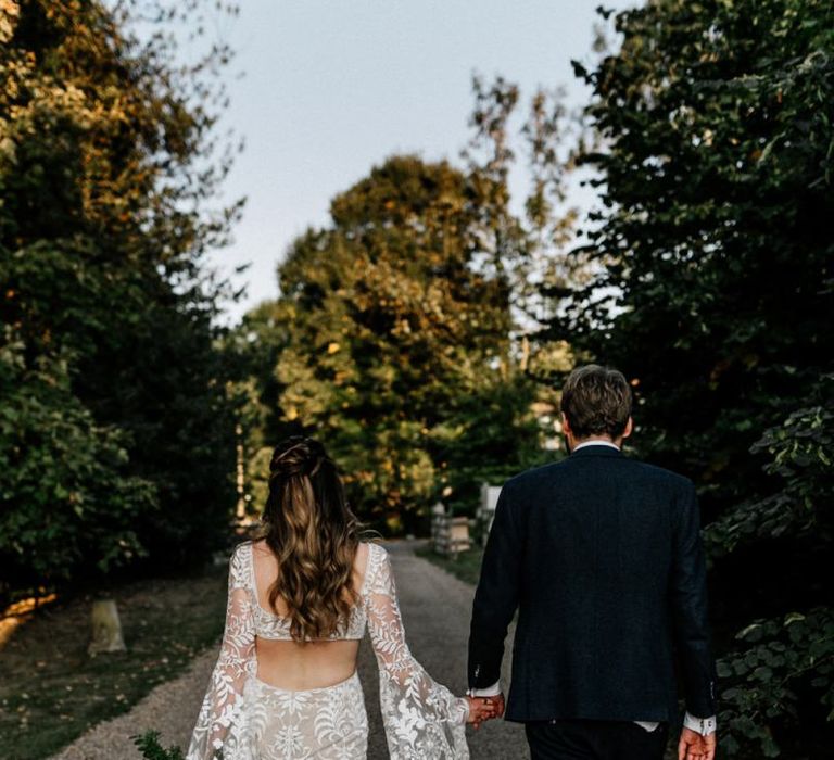 Bride in boho wedding dress with Bell sleeves and cut away back detail