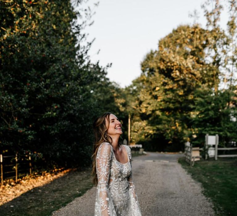 Bride in boho wedding dress with bell sleeves and lace detail