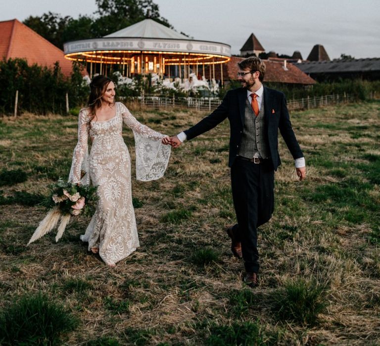 Bride and Groom portrait in front of the carousel at Preston Court wedding venue