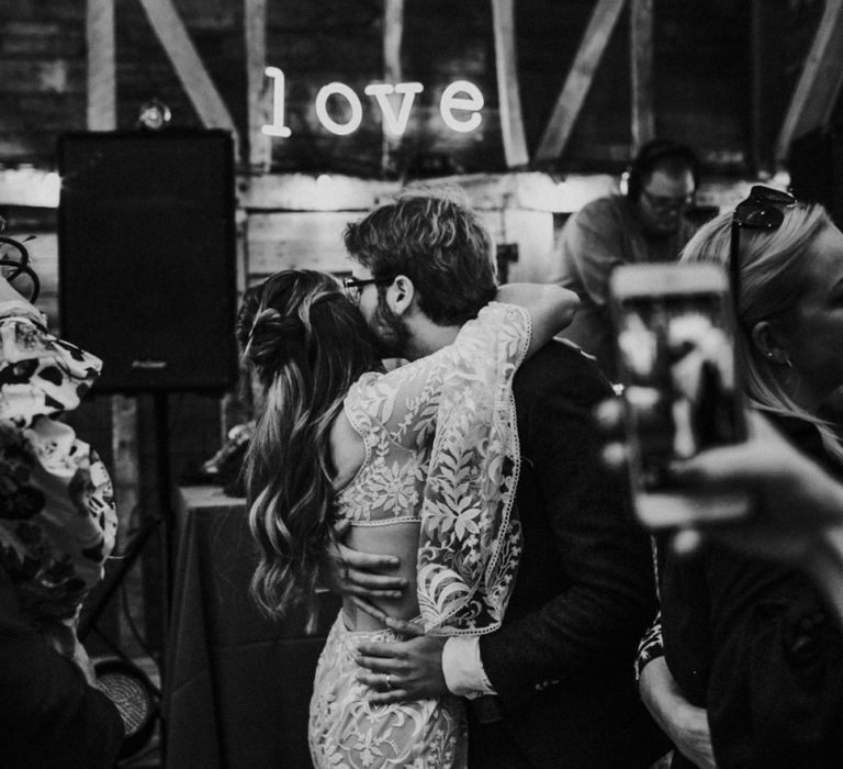 First dance at Preston court under a neon Love sign with Boho bride in lace wedding dress