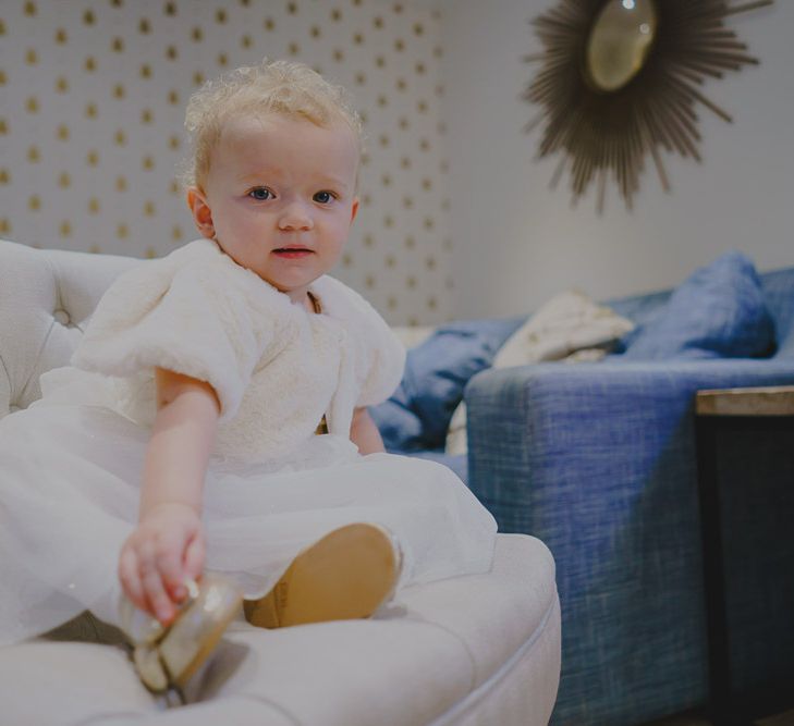 Baby flower girl in faux fur coverup