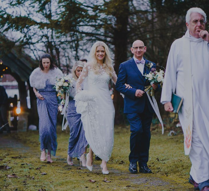 Bridal party walking through the church courtyard at South Farm wedding