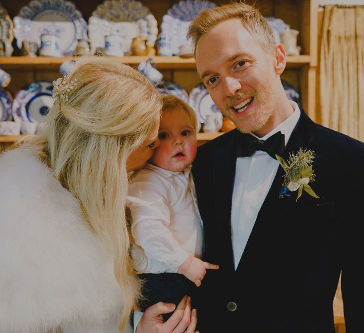 Portrait of bride, groom and their baby boy.