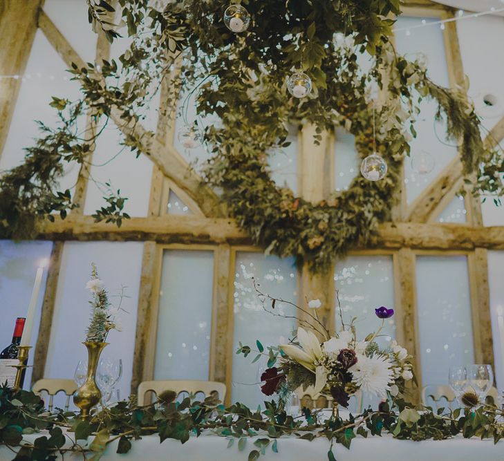 Top table at South Farm decorated with foliage and fairy lights