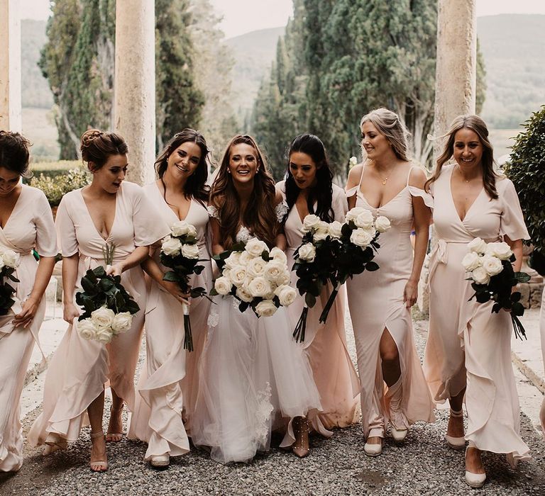 Pink bridesmaid dresses with white bouquets with bride in Galia Lahav wedding dress