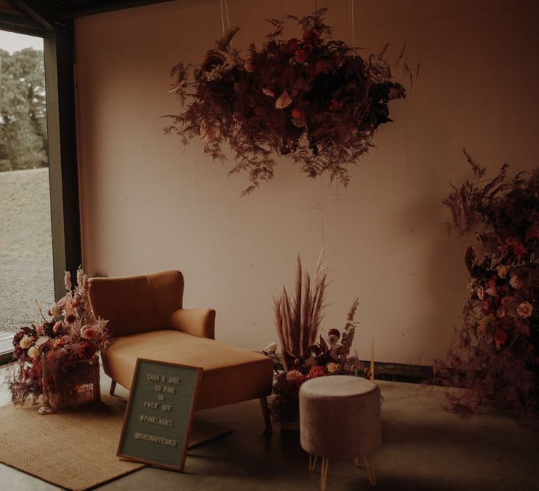 Relaxed seating area at The Giraffe Shed with flower installation