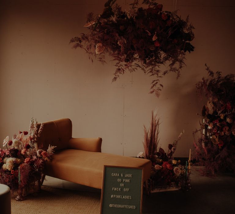 Floral installation and chaise seating area at The Giraffe Shed