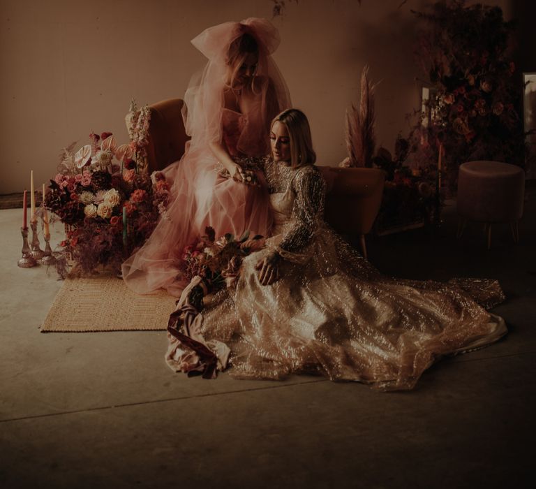 Lesbian couple in gold glitter and pink dress for wedding inspiration at The Giraffe Shed