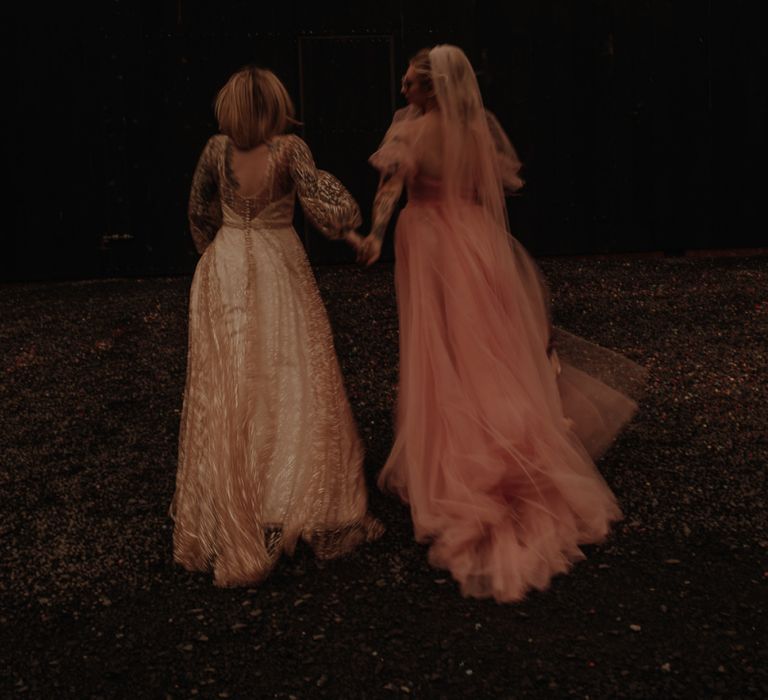 Two brides in gold glitter and pink dress for wedding inspo at The Giraffe Shed