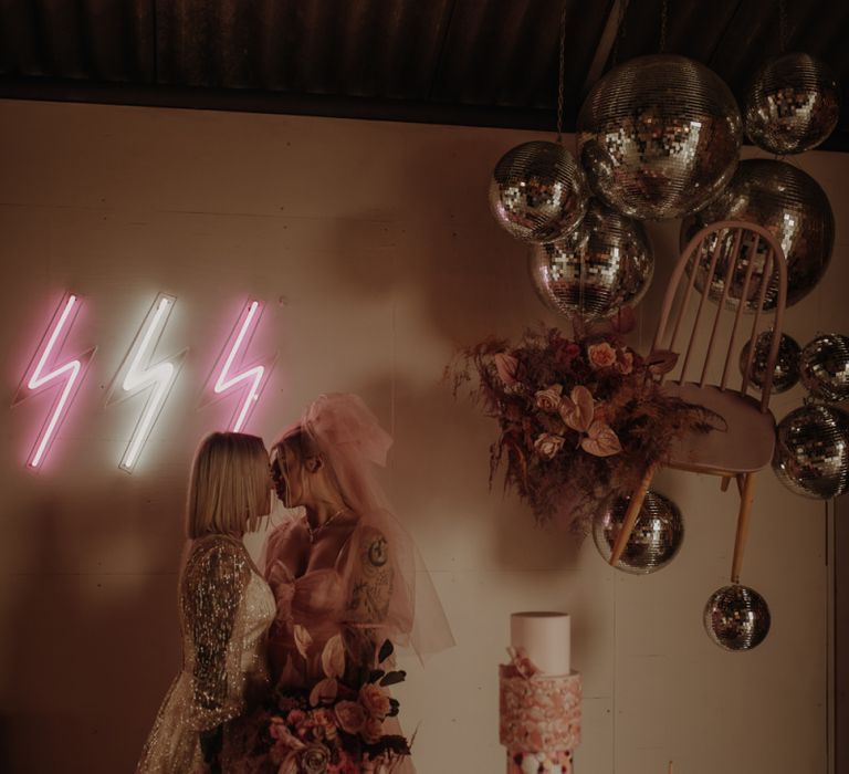 Bride in pink dress for wedding with retro dessert table