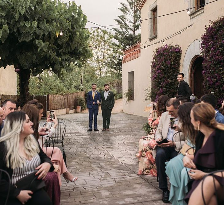 Outdoor Wedding Ceremony Groom Entrance with Groom in Forest Green Wedding Suit