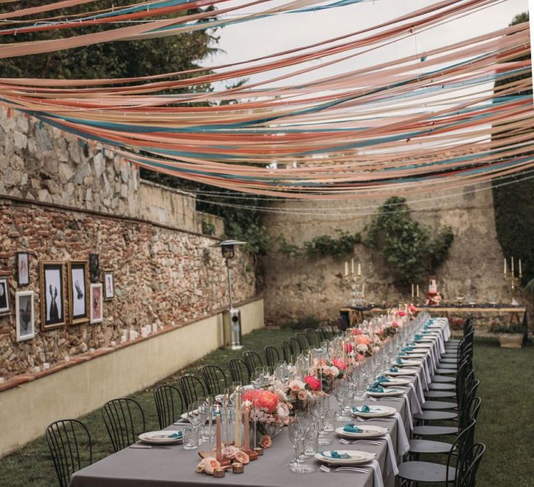 Long Wedding Reception Table with Ribbon Canopy and Floral Table Decor