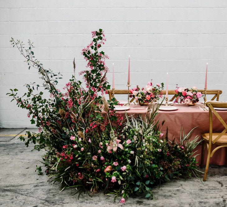 Table Decor with Pink Table Cloth, Taper Candles and Large Floral Arrangement