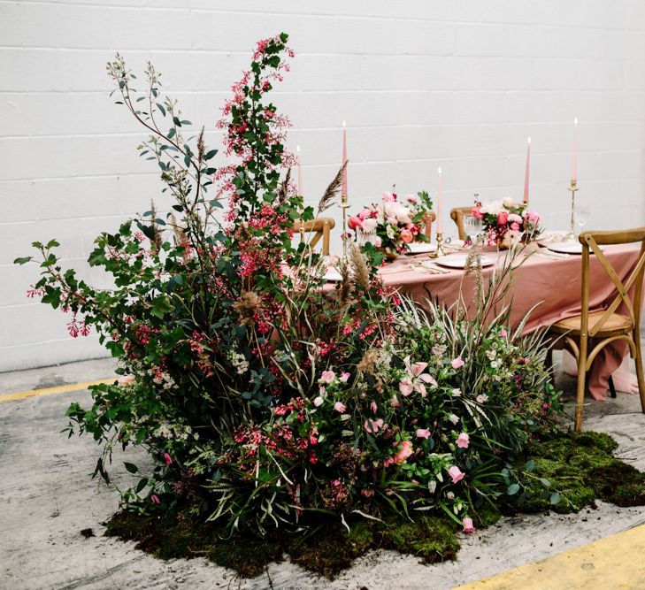 Table Decor with Pink Table Cloth, Taper Candles and Large Floral Arrangement