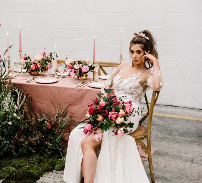 Bride in Illusion Lace Bodice Wedding Dress Holding a Deep Pink and Green Wedding Bouquet