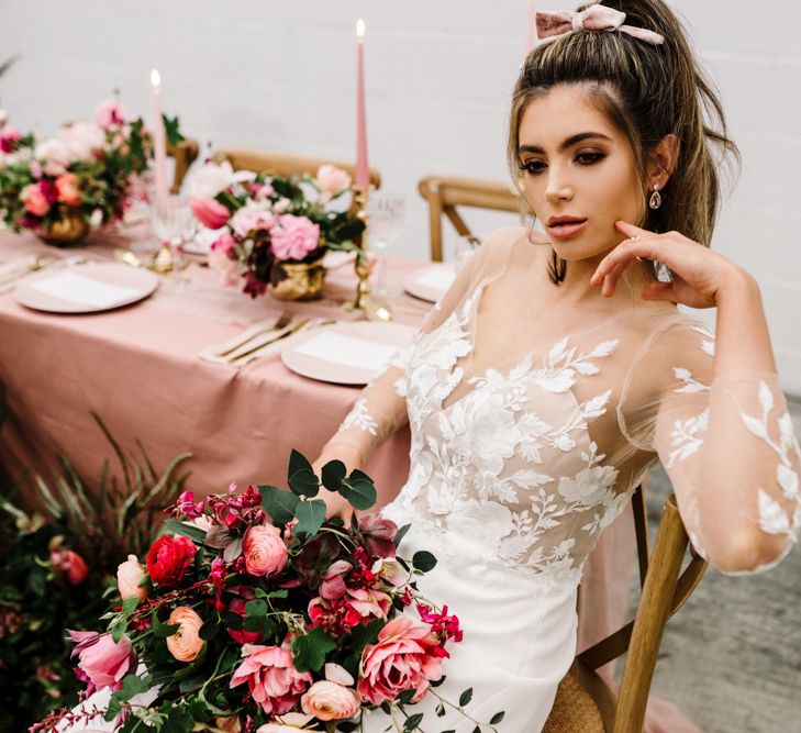 Beautiful Bride with Natural Makeup in a Illusion Lace Wedding Dress Holding a Deep Pink and Green Bouquet