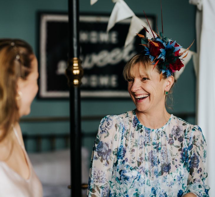 Bride's mother smiles at sister of the bride