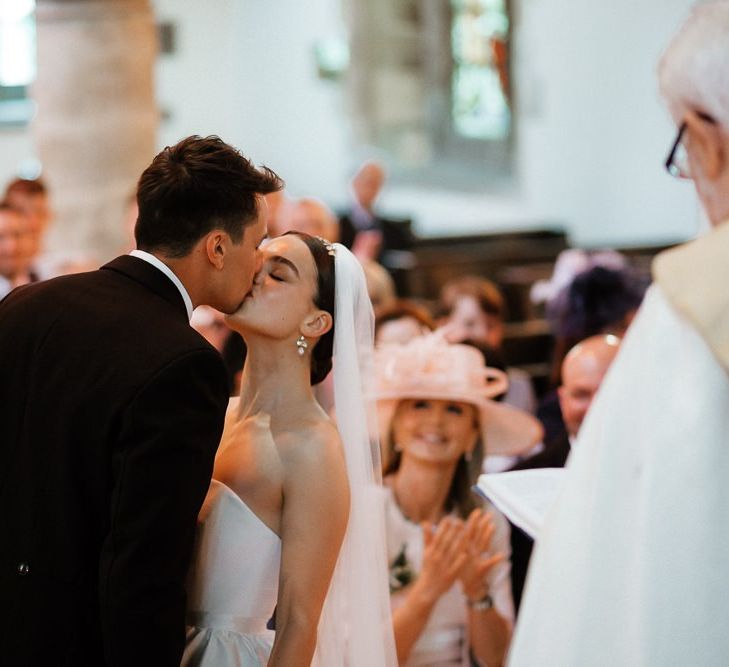 Bride and Groom Kiss During Ceremony