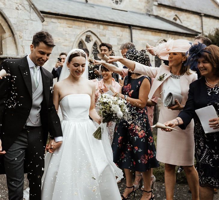 Confetti Exit For Bride In Strapless Wedding Dress And Groom  In Tail Suit