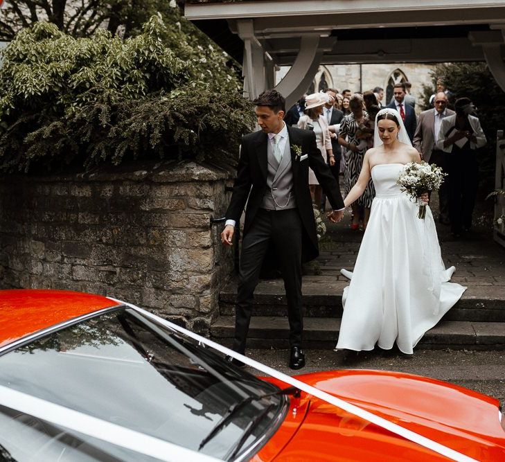 Bride and Groom Make Their Way To Wedding Transport