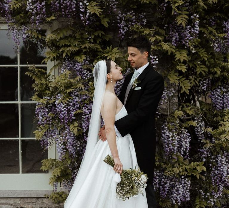 Bride In Strapless Wedding Dress With Bouquet And Veil