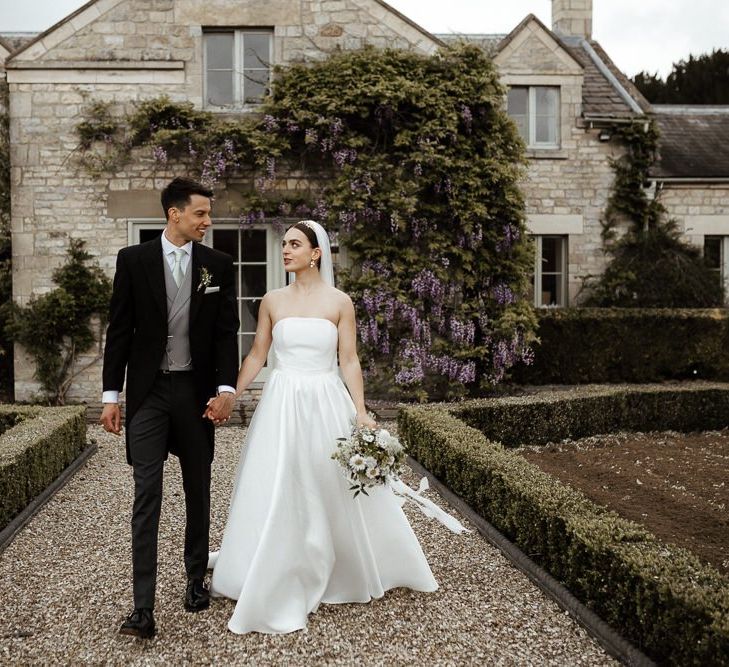 Bride In Strapless Wedding Dress With Bouquet And Veil